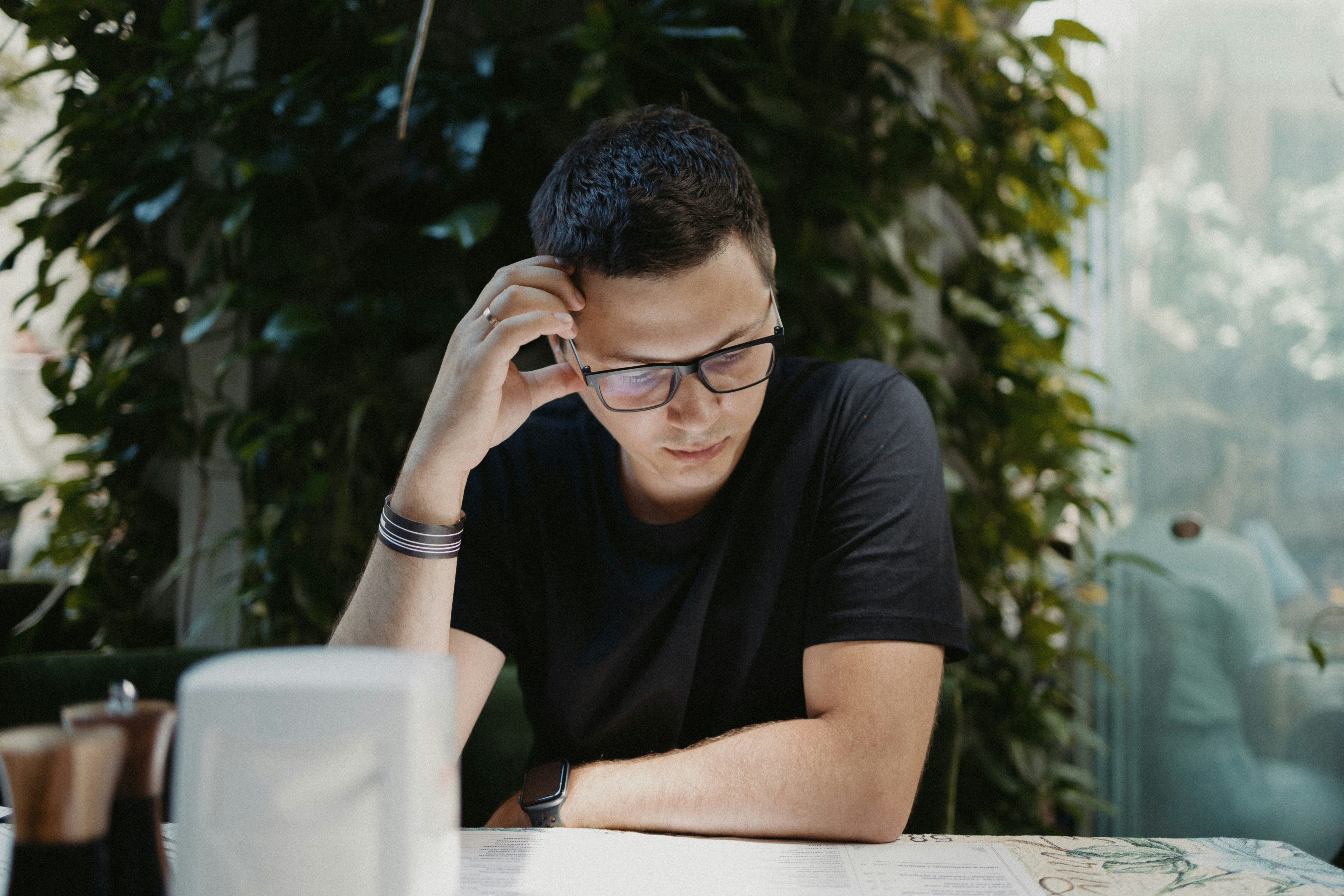 man in black crew neck t-shirt wearing black framed eyeglasses